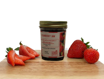 Double L Ranch Strawberry Jam jar on a board with fresh strawberry slices